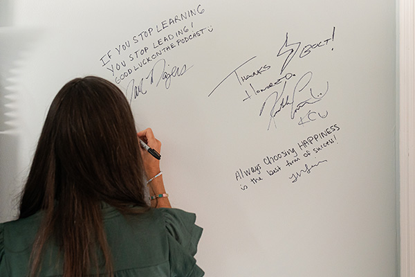 Christine Hockman signing wall in the BOLT podcast studio