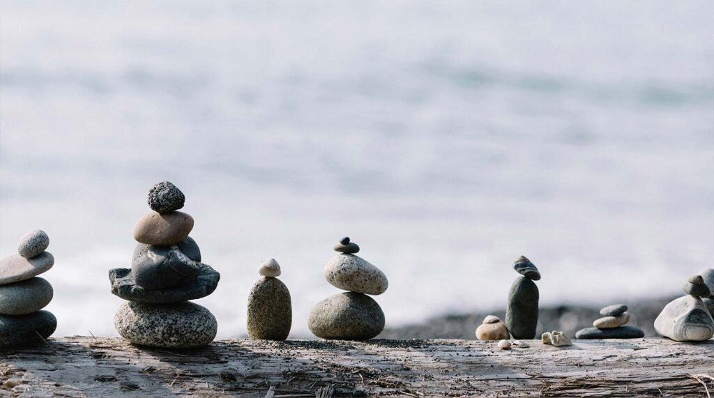 ocean with rocks stacked on each other